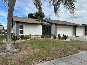 Charming single-story home with a two-car garage and manicured landscaping at 404 Elder St # 230, Englewood, FL 34223