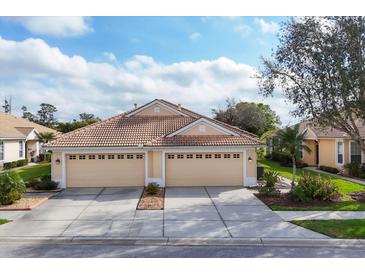 Charming one story home featuring a three-car garage and a beautifully landscaped yard at 4301 Whispering Oaks Dr, North Port, FL 34287