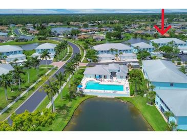 An aerial view features a pool, lovely landscaping, and a view of the community with beautiful Florida sunshine at 5744 Sabal Trace Dr # 202Bd5, North Port, FL 34287