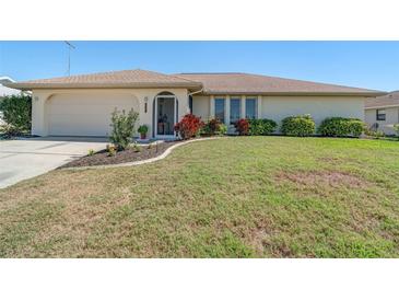 Charming single story home with an attached two car garage and colorful landscaping at 5875 Jackson, Venice, FL 34293