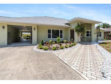 Charming single-story home featuring an attached carport, and attractive landscaping at 771 Stewart St, Englewood, FL 34223
