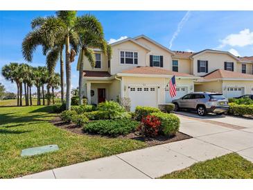 Charming two-story home with a well-manicured lawn, lush landscaping, and a spacious driveway leading to an attached garage at 1050 Jonah Dr, North Port, FL 34289