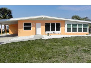 Charming single-story home with a well-manicured lawn, covered carport and clean landscaping at 231 Redwood Rd, Venice, FL 34293