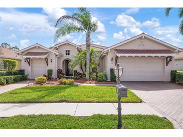 Stunning single-Gathering home with a meticulously maintained lawn, mature landscaping, and a private two-car garage at 297 Martellago Dr, North Venice, FL 34275