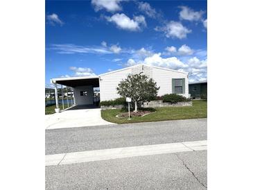 Charming single-story home featuring a carport, landscaped yard, and meticulous, low maintenance curb appeal at 495 Schooner St, North Port, FL 34287