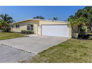 Charming single-story home featuring an attached two-car garage and a well-maintained front yard at 501 Dona Dr, Nokomis, FL 34275