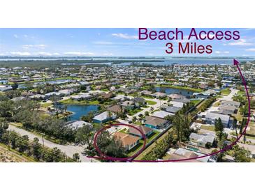 Beautiful aerial view of a residential community with waterfront homes and easy access to the beach, just 3 miles away at 8603 46Th Avenue W Cir, Bradenton, FL 34210