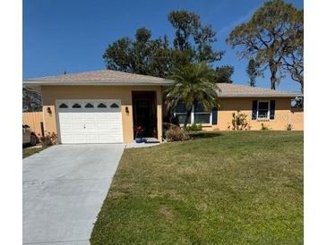 Charming one-story home featuring a well-manicured lawn, a front yard palm tree, and a two car garage at 1278 Olympia Rd, Venice, FL 34293