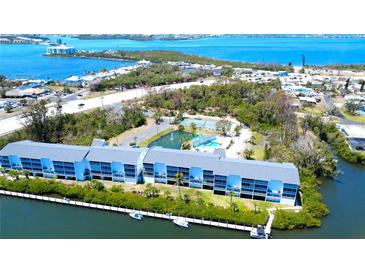 Beautiful waterfront building with community pool, tennis courts, and lush landscaping at 1401 S Mccall Rd # 106, Englewood, FL 34223