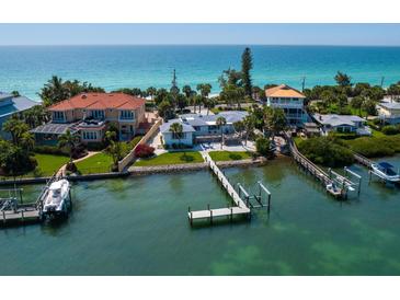 Stunning waterfront homes with private docks and beach access boast incredible views of the turquoise ocean waters at 1604 Casey Key Rd, Nokomis, FL 34275