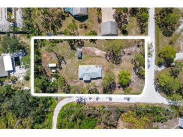 An aerial view of a property showcasing the home, surrounding landscape, and lot size at 1871 Bridge St, Englewood, FL 34223