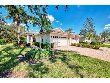 Charming single-story home featuring a brick driveway, well-manicured lawn, and an attached two-car garage at 4301 Nizza Ct, Venice, FL 34293