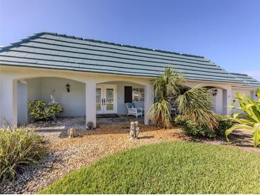 Charming home featuring a light blue tile roof and a well-manicured lawn at 601 Apalachicola Rd, Venice, FL 34285
