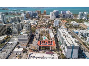 Stunning aerial view of the building showcasing beautiful city and water views at 100 Central Ave # C619, Sarasota, FL 34236
