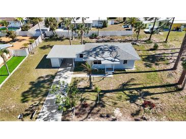 Aerial view of home featuring a well-manicured lawn, and driveway at 1075 Falcon Rd, Venice, FL 34293