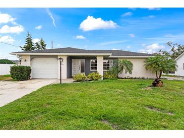 Charming single-story home with a well-maintained lawn, lush landscaping, and a convenient attached garage at 427 Canterbury Rd, Venice, FL 34293