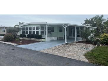 Charming single-story home featuring a covered carport and well-manicured landscaping at 524 S Cervina Dr, Venice, FL 34285