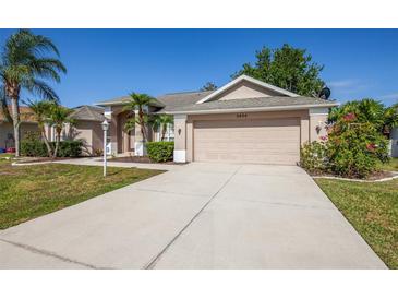 Charming home featuring a two-car garage, well-maintained landscaping, and a spacious driveway at 5824 Mckinley Rd, Venice, FL 34293