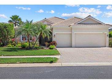 Charming home with well-maintained landscaping, two-car garage, and inviting curb appeal at 12127 Granite Woods Loop, Venice, FL 34292