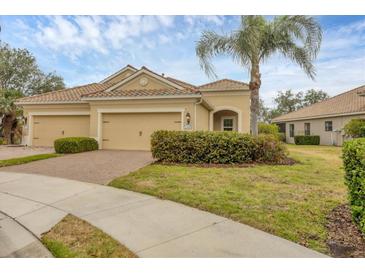 Charming single-story home with a tile roof, well-manicured lawn, and a two-car garage at 12198 Sebring Ln, Venice, FL 34293