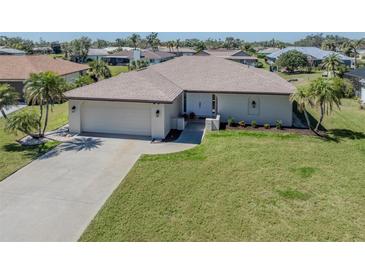 Charming single-story home with a well-manicured lawn and a two-car garage at 1602 Jim Jim Ct, Venice, FL 34293