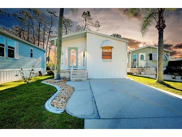 Charming home with a well-manicured lawn and a cozy, inviting facade at 223 Lancer Dr, Nokomis, FL 34275