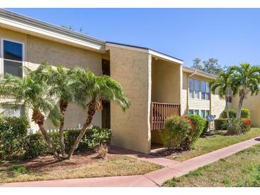 Inviting condo exterior featuring a private balcony and lush tropical landscaping at 3417 Clark Rd # 217, Sarasota, FL 34231