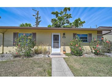 Charming front entrance of home with a well-manicured lawn and walkway to the front door at 4437 Tippecanoe Trl # 6, Sarasota, FL 34233