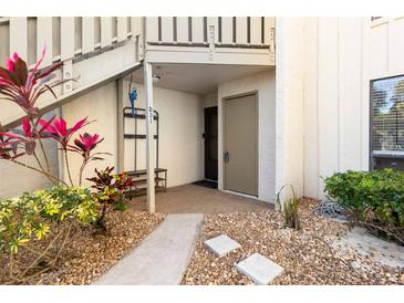 The front entrance is nicely landscaped with flowers and stone at 6157 Midnight Pass Rd # D31, Sarasota, FL 34242
