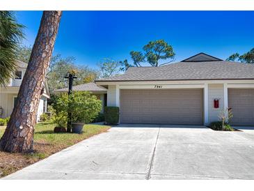 Charming home featuring a two-car garage, well-manicured landscaping, and a welcoming entrance at 7941 Pineglen Ct # 37, Sarasota, FL 34238