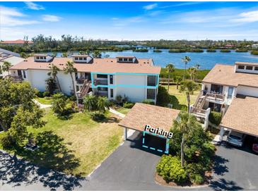 Waterfront condo featuring a covered parking space and gorgeous views of the bay at 990 Bird Bay Way # 258, Venice, FL 34285