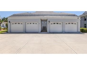 A multi-car garage with concrete driveway offers plenty of parking at 1041 Capri Isles Blvd # 224, Venice, FL 34292