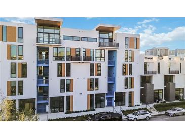 Modern townhouse exterior boasting contemporary design with balconies and ample street parking at 1558 4Th St # 208, Sarasota, FL 34236
