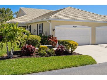 Charming one-story home featuring a well-manicured lawn and a convenient two-car garage at 1567 Monarch Dr, Venice, FL 34293