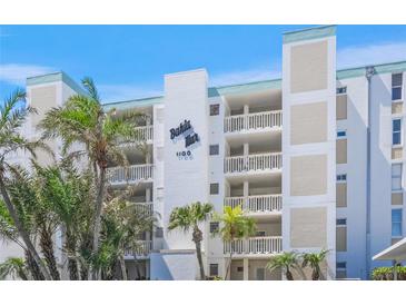 Bahia Mar condominium building with multiple balconies and lush landscaping at 1100 Tarpon Center Dr # 104, Venice, FL 34285