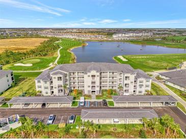 Luxury condo complex featuring covered parking, a pristine lake, and a beautiful golf course at 12140 Wellen Golf St # 401, Venice, FL 34293