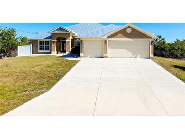 Charming home with a well-manicured lawn, neutral stucco, and a convenient two-car garage and spacious driveway at 13452 High Springs Ave, Port Charlotte, FL 33981