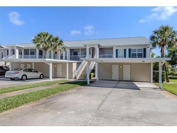 Charming condo building with covered parking, lush landscaping, and easy access to nearby amenities at 432 Sunset Lake Blvd # 205, Venice, FL 34292
