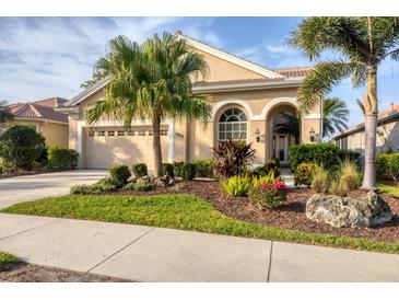 Charming single-story home with lush landscaping, a large garage, and a beautifully designed stucco facade at 5223 Pine Shadow Ln, North Port, FL 34287