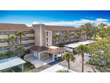 Exterior of a well-maintained multi-story condo building with covered parking at 839 Wexford Blvd # 839, Venice, FL 34293