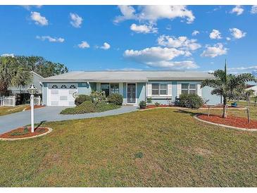 Charming single story home with well-manicured lawn and mature landscaping at 8432 Culebra Ave, North Port, FL 34287