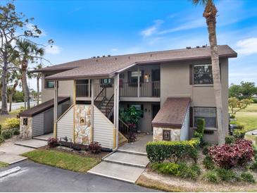 Charming condo complex featuring stone accents, inviting stairs, and well-maintained landscaping at 925 Capri Isles Blvd # 4, Venice, FL 34292