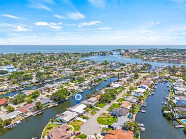 Stunning aerial view showcasing the waterfront community with access to open water and clear blue skies at 4255 13Th Ne Ln, St Petersburg, FL 33703