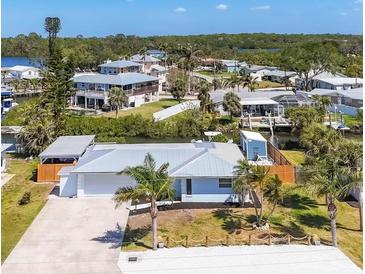 Waterfront home featuring a new roof, lush landscaping and an expansive driveway at 507 Buena Vista Dr, Nokomis, FL 34275