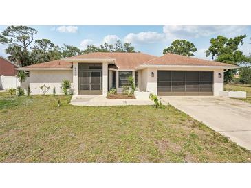 Charming single-story home featuring a well-maintained lawn and a screened front porch at 5417 Maccaughey Dr, North Port, FL 34287
