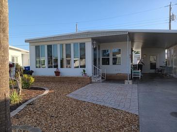 Charming home featuring a covered carport, manicured landscaping, and a welcoming entryway at 638 Leisure, Venice, FL 34285