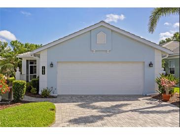 Charming home featuring a two-car garage and paved driveway at 1625 Lancashire Dr, Venice, FL 34293