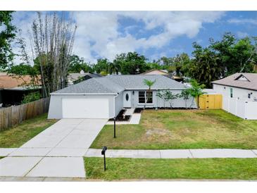 Single-Gathering home featuring a well-kept lawn, front garden, and an attached garage at 4068 Palau Dr, Sarasota, FL 34241