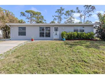Charming single-story home featuring a well-maintained lawn and a welcoming front entrance at 8132 Coco Solo Ave, North Port, FL 34287