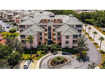Stunning exterior view of a condo with a landscaped roundabout and lush tropical landscaping at 1711 Gondola Park Dr # 1711, Venice, FL 34292